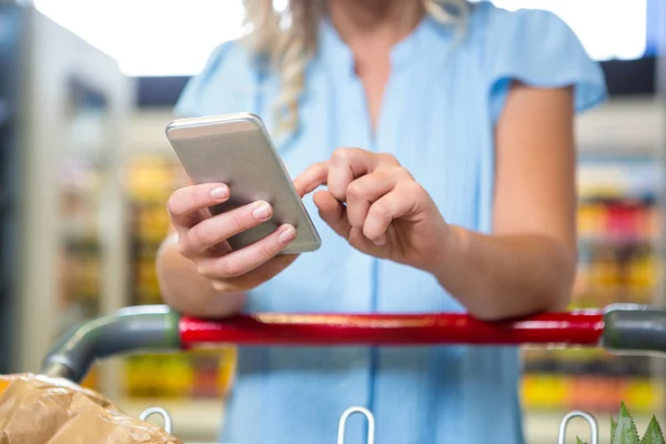 Kvinna med vagn med smartphone — Stockfoto