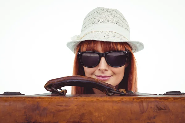 Lachende hipster vrouw achter een koffer — Stockfoto