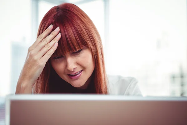 Hipster businesswoman having a headache — Stock Photo, Image