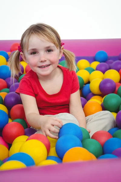 Cute smiling girl in sponge ball pool — Stock Photo, Image