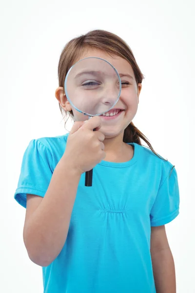 Standing girl using magnifying glass — Stock Photo, Image