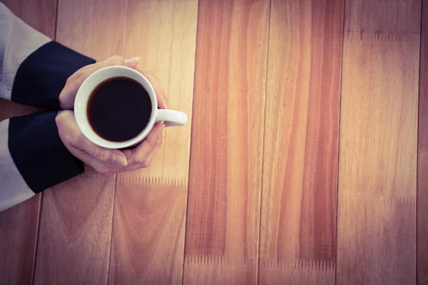 Hipster businesswoman holding a cup of coffee — Stock Photo, Image