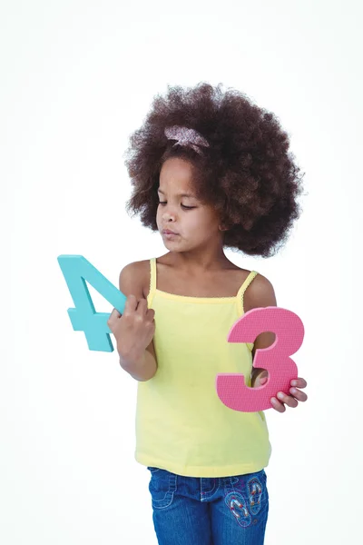 Standing girl looking at sponge numbers — Stock Photo, Image
