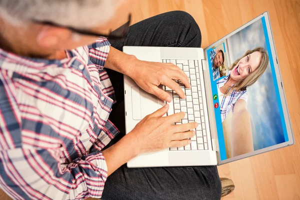 Man använder laptop medan du sitter på golvet — Stockfoto