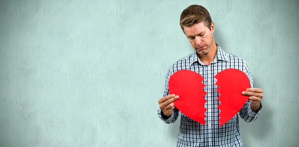 Sad man holding a broken card — Stock Photo, Image