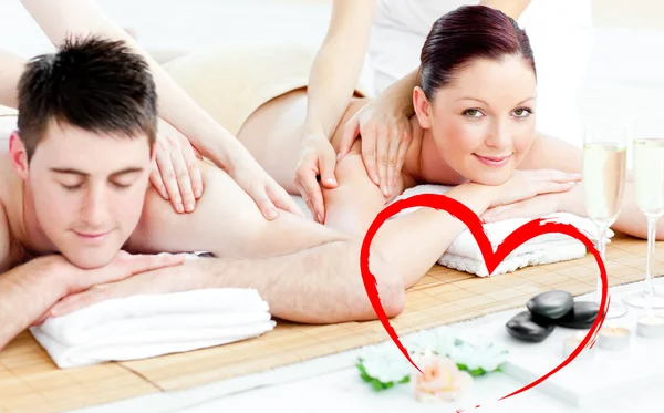 Attractive young couple enjoying a back massage — Stock Photo, Image