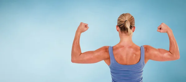 Rear view of woman flexing muscles — Stock Photo, Image