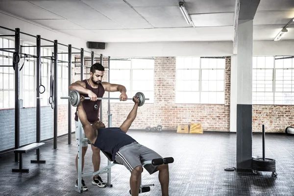 Treinador ajudando o homem muscular — Fotografia de Stock