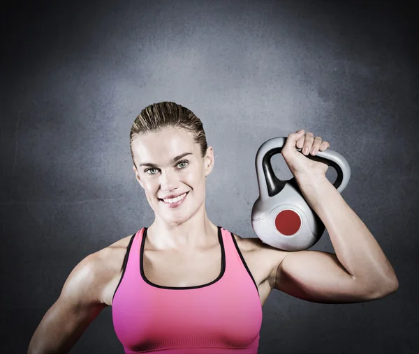 Muscular mujer levantando pesadas pesas kettlebell — Foto de Stock