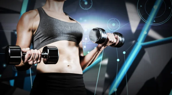 Muscular woman lifting heavy dumbbells — Stock Photo, Image