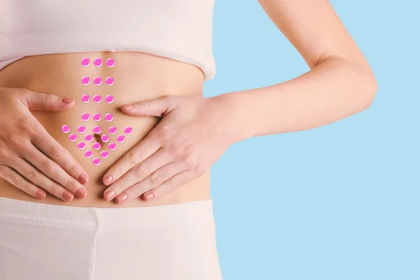 Slim woman touching her belly — Stock Photo, Image