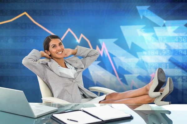 Businesswoman relaxing in a swivel chair — Stock Photo, Image