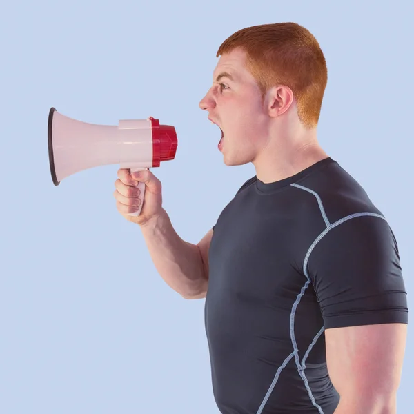 Angry rugby player yelling through the megaphone — Stock Photo, Image