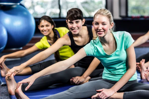 Fit smiling group doing stretching — Stock Photo, Image