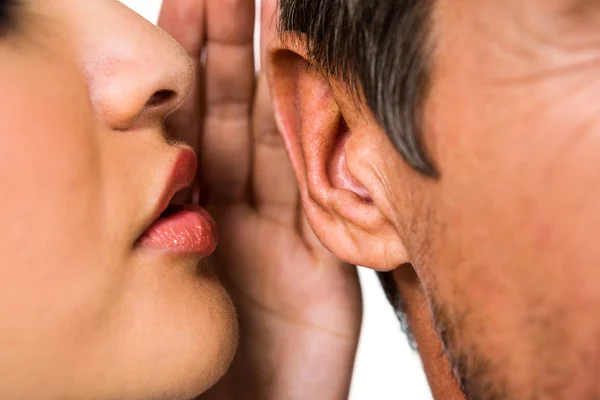 Woman whispering in man ear — Stock Photo, Image