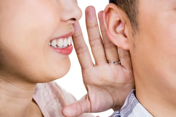 Woman whispering secret to husband — Stock Photo, Image