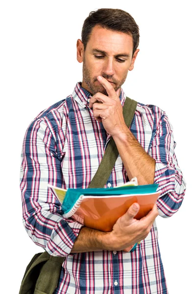 Nachdenklicher Mann steht mit Notizblock in der Hand — Stockfoto
