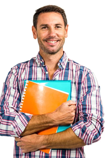 Sorrindo homem de pé segurando blocos de notas — Fotografia de Stock