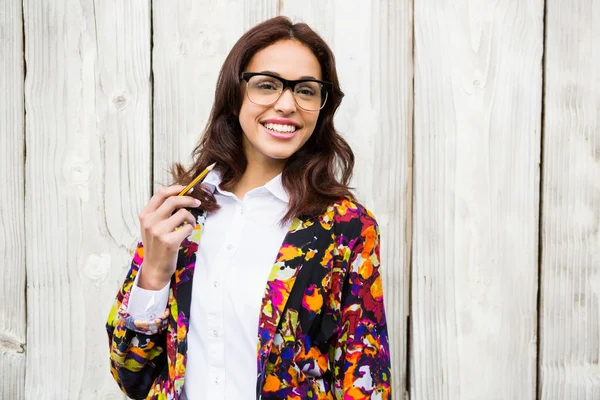 Smiling hipster woman with pencil — Stock Photo, Image