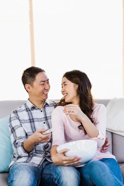 Happy man looking at woman while sitting on sofa — Stock Photo, Image