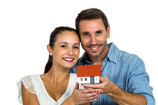 Excited couple holding house model — Stock Photo, Image