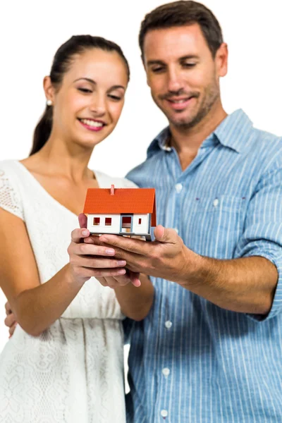 Young couple holding house model Royalty Free Stock Images