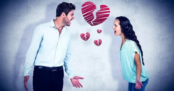 Smiling couple holding red heart shape — Stock Photo, Image