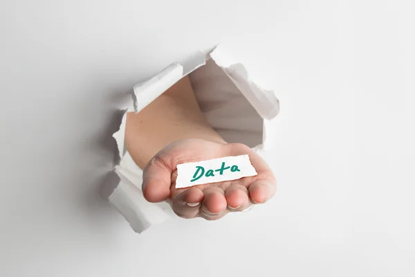 Hand bursting through paper against data — Stock Photo, Image