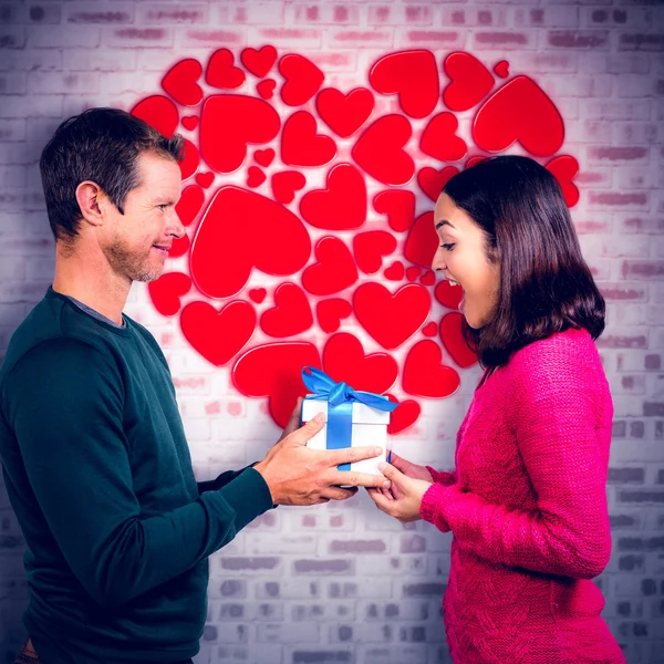 Pasangan tersenyum memegang bentuk hati merah — Stok Foto