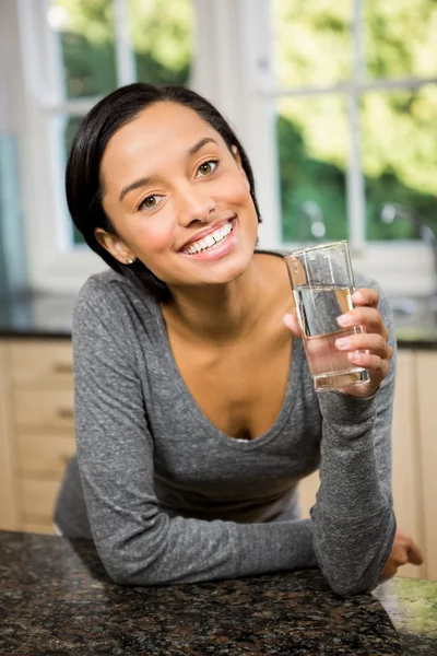 Bruna sorridente che tiene un bicchiere d'acqua — Foto Stock