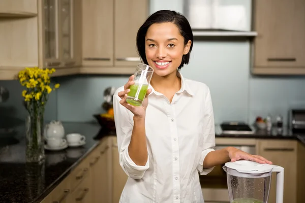 Brunette holding glass of smoothie — Stock Photo, Image