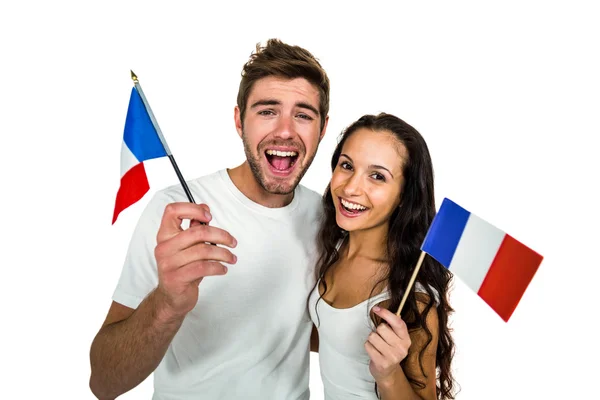 Pareja sonriente sosteniendo bandera francesa — Foto de Stock