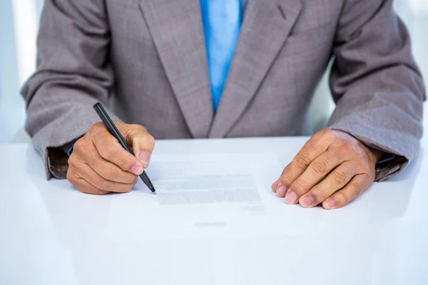 Serious businessman making notes — Stock Photo, Image