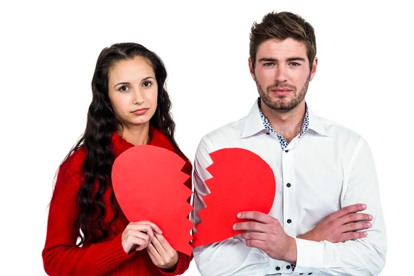 Paar hält Herzhälften — Stockfoto