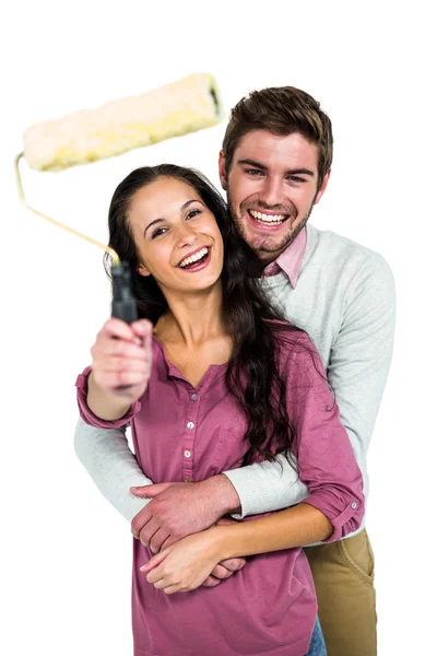 Sonriente pareja sosteniendo pintura rodillo — Foto de Stock