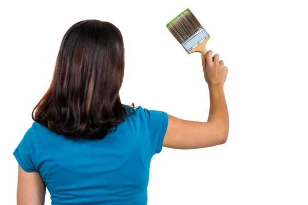 Visão traseira da mulher segurando pincel de pintura — Fotografia de Stock