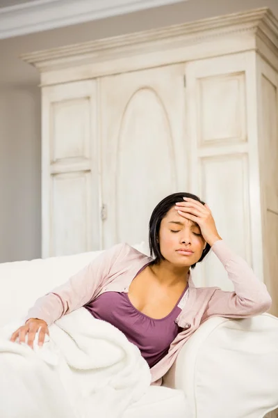 Frowning brunette with hand on face — Stock Photo, Image