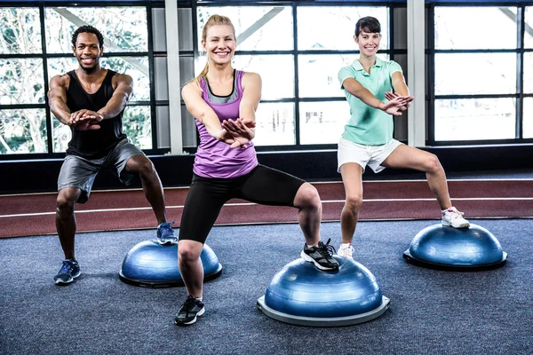 Fit people doing exercise with bosu ball — Stock Photo, Image