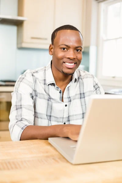 Handsome man using laptop — Stock Photo, Image