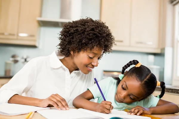 Mother checking daughters homework — Stock Photo, Image