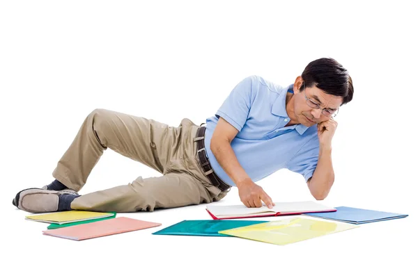 Smiling man reading books — Stock Photo, Image