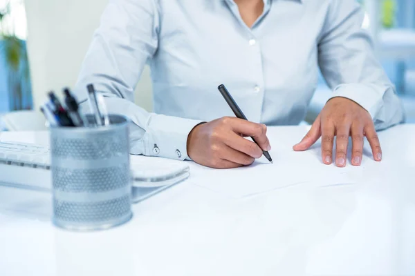 Businesswoman writing on white paper Stock Picture