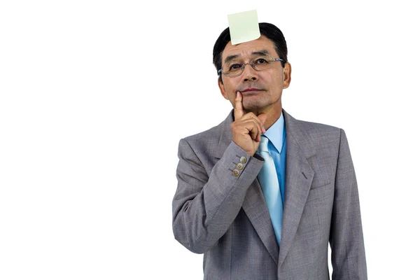 Businessman with blank note on forehead — Stock Photo, Image