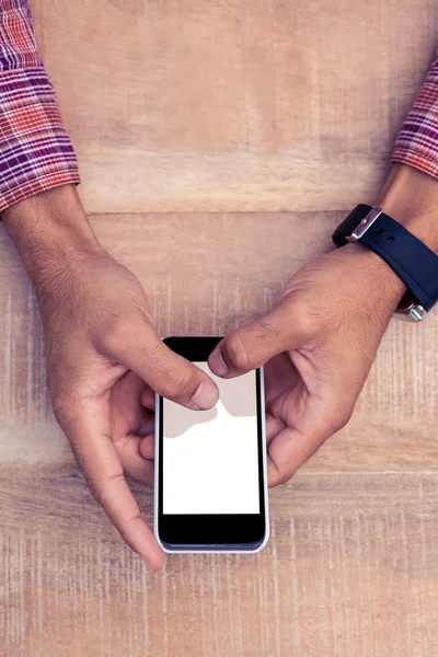 Person mit Smartphone am Schreibtisch — Stockfoto