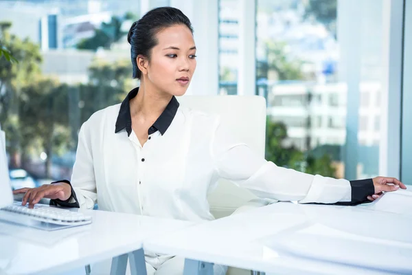 Mujer de negocios sonriente escribiendo en su computadora —  Fotos de Stock