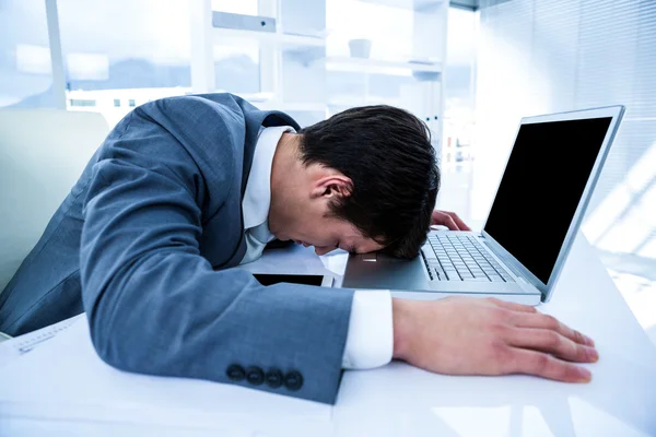 Businessman lying on his desk — Stock Photo, Image