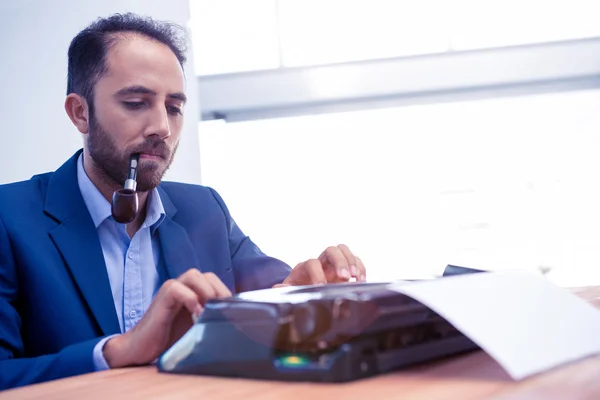 Hipster businessman working on typewriter — Stock Photo, Image