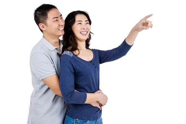 Счастливая пара с женщиной, указывающей вверх — стоковое фото