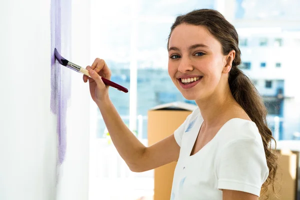 Girl smiling and painting — Stock Photo, Image