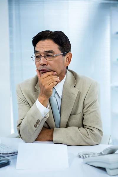 Undecided businessman at his computer — Stock Photo, Image